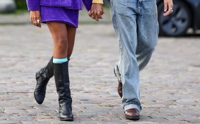 woman and man walking hand in hand wearing fall boots