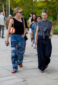 COPENHAGEN, DENMARK - AUGUST 08: A guest wears denim jeans & a guest wears grey sleeveless jumper outside Marimekko during day four of the Copenhagen Fashion Week (CPHFW) SS25 on August 08, 2024 in Copenhagen, Denmark. (Photo by Christian Vierig/Getty Images)