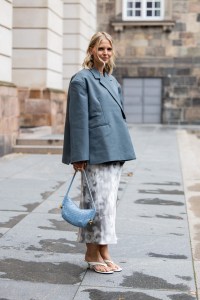 COPENHAGEN, DENMARK - AUGUST 08: Hollie Mercedes Peters wears grey blazer, blue bag, skirt outside Rotate during day four of the Copenhagen Fashion Week (CPHFW) SS25 on August 08, 2024 in Copenhagen, Denmark. (Photo by Christian Vierig/Getty Images)