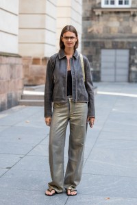 COPENHAGEN, DENMARK - AUGUST 08: Jacqueline Zelwis wears brown leather jacket, golden pants outside Rotate during day four of the Copenhagen Fashion Week (CPHFW) SS25 on August 08, 2024 in Copenhagen, Denmark. (Photo by Christian Vierig/Getty Images)