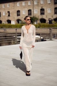 COPENHAGEN, DENMARK - AUGUST 08: Sophia Geiss wears a long beige knitted maxi dress, black flip flops, sandals and black bag during day four of the Copenhagen Fashion Week (CPHFW) SS25 on August 08, 2024 in Copenhagen, Denmark. (Photo by Raimonda Kulikauskiene/Getty Images)