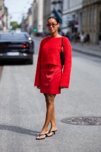 COPENHAGEN, DENMARK - AUGUST 08: Amaka Hamelijnck wears red wool, skirt, black bag outside Gestuz during day four of the Copenhagen Fashion Week (CPHFW) SS25 on August 08, 2024 in Copenhagen, Denmark. (Photo by Christian Vierig/Getty Images)