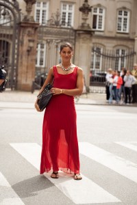 COPENHAGEN, DENMARK - AUGUST 08: A guest wears long red sheer maxi dress, black bag, silver layered necklaces, red scrunchy for hair is seen outside the Gestuz show during day four of the Copenhagen Fashion Week (CPHFW) SS25 on August 08, 2024 in Copenhagen, Denmark. (Photo by Raimonda Kulikauskiene/Getty Images)