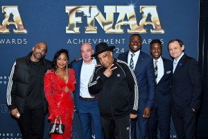 NEW YORK, NEW YORK - DECEMBER 04: Darryl McDaniels (L), Joseph Reverend Run Simmons (C), Grant Holloway (3rd L) and Bjorn Gulden (R) attend Footwear News Achievement Awards (FNAAs) 2024 at Cipriani South Street on December 04, 2024 in New York City.  (Photo by Roy Rochlin/Footwear News via Getty Images)