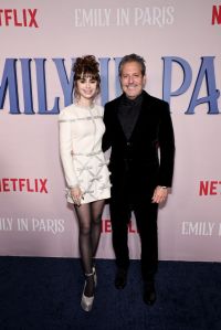 NEW YORK, NEW YORK - DECEMBER 15: Lily Collins and Darren Starr attend the Emily In Paris French Consulate Red Carpet at French Consulate on December 15, 2022 in New York City. (Photo by Jamie McCarthy/Getty Images for Netflix)