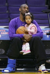 LOS ANGELES - JANUARY 19:  Kobe Bryant #8 of the Los Angeles Lakers sits with his daughter, Natalia, before the game against the Minnesota Timberwolves as he recovers from an ankle injury at Staples Center January 19, 2005 in Los Angeles, California. NOTE TO USER: User expressly acknowledges and agrees that, by downloading and/or using this Photograph, user is consenting to the terms and conditions of the Getty Images License Agreement.  (Photo by Lisa Blumenfeld/Getty Images)