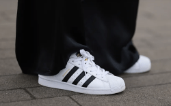 woman wearing adidas superstar shoes that are on sale for presidents day 2024