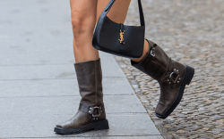 woman wears harness brown boots and a black YSL bag YSL during Berlin Fashion Week